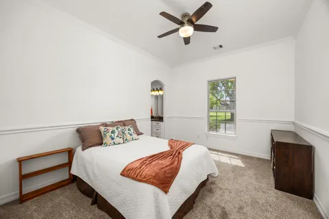 a bedroom with a large bed and a window