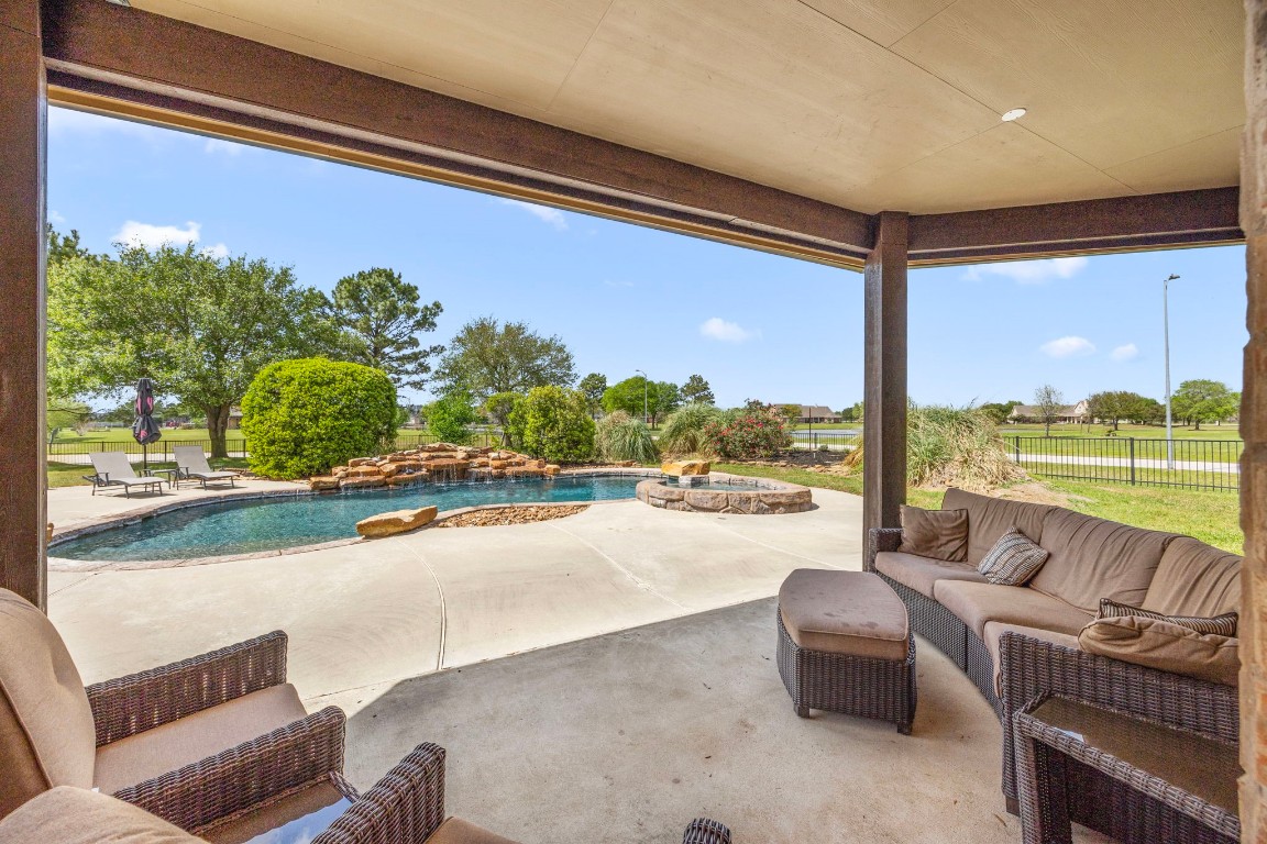 4611 Oasis Point Katy, TX 77493 - Photo 30 of 41 a living room with furniture and a floor to ceiling window