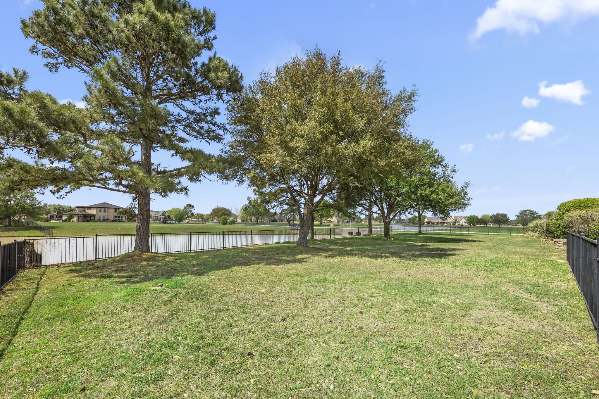 4611 Oasis Point Katy, TX 77493 - Photo 34 of 41 The iron gate seen to the right encloses the side yard, perfect for pets and the raised garden beds you will find there.