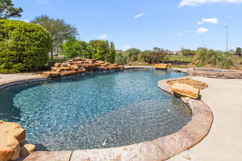 a view of a swimming pool with an outdoor space and seating area