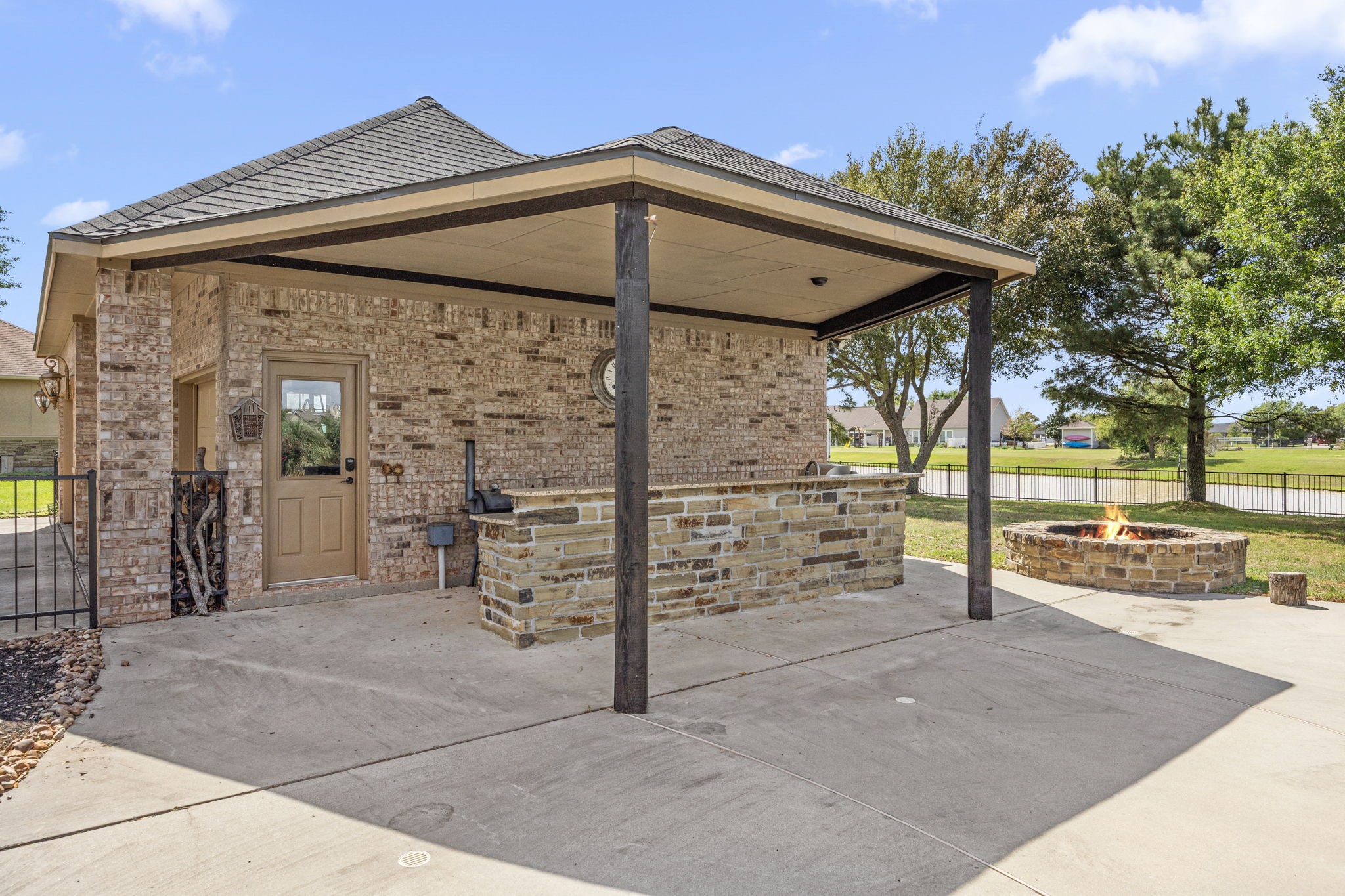 4611 Oasis Point Katy, TX 77493 - Photo 37 of 41 Your outdoor kitchen, adjacent to the detached 3-car garage, is equipped with instant hot water and a gas grill with rotisserie attachment.