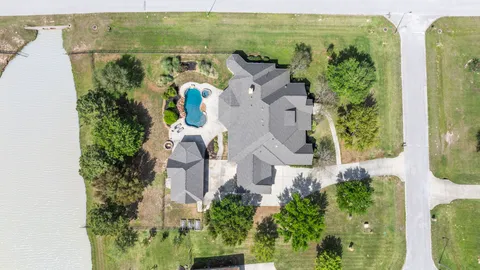 an aerial view of a house with outdoor space
