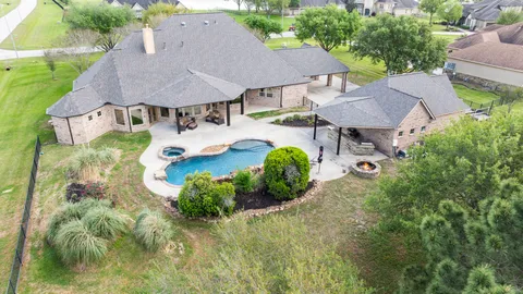 an aerial view of a house with garden space and a patio