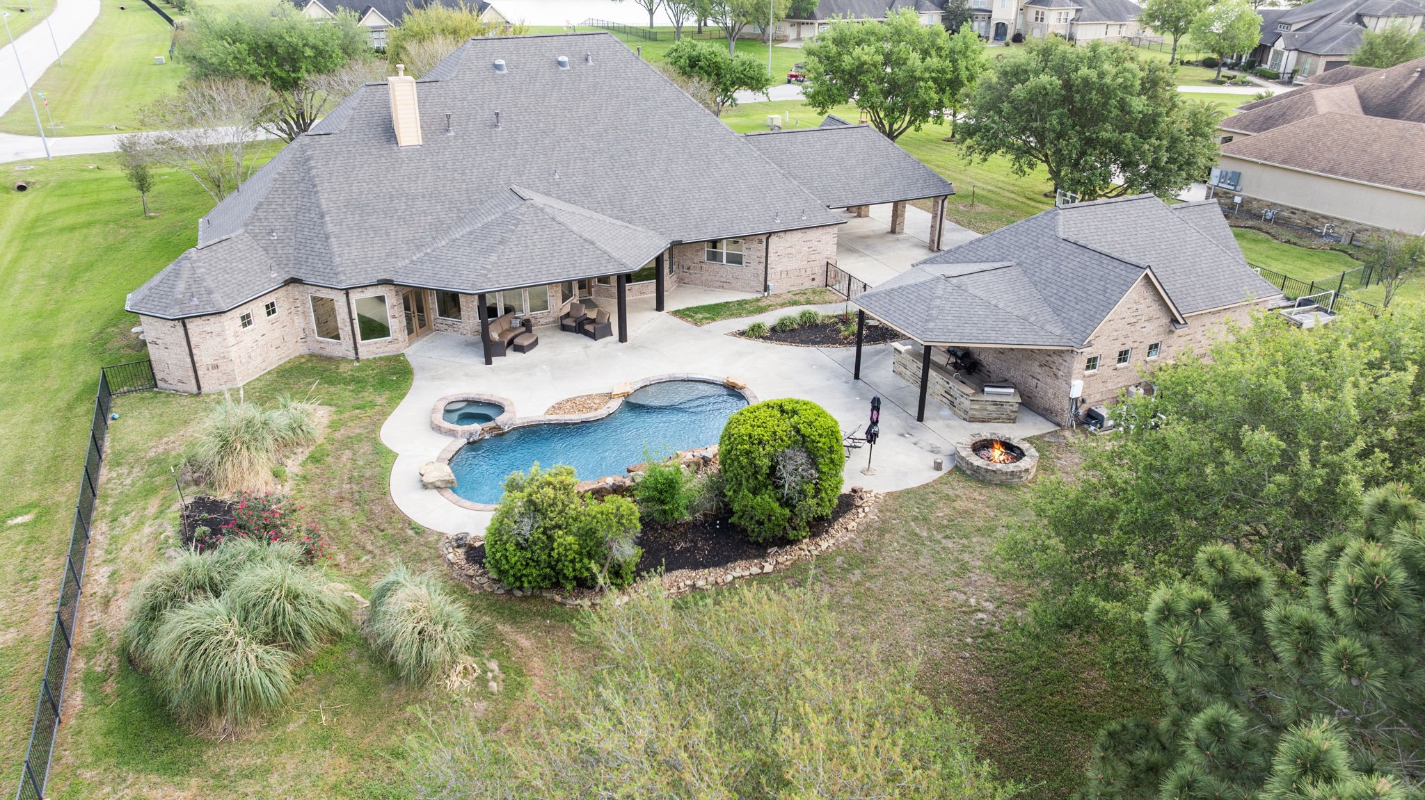 4611 Oasis Point Katy, TX 77493 - Photo 41 of 41 Don't sacrifice green space for the pool! This lot is landscaped to provide impressive water views without sacrificing privacy when desired.