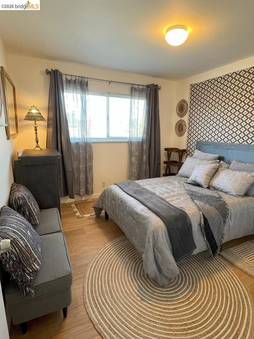 1728 Seventh Street, Unit F Berkeley, CA 94710 - Photo 4 of 6 bedroom with wood finished floors and multiple windows