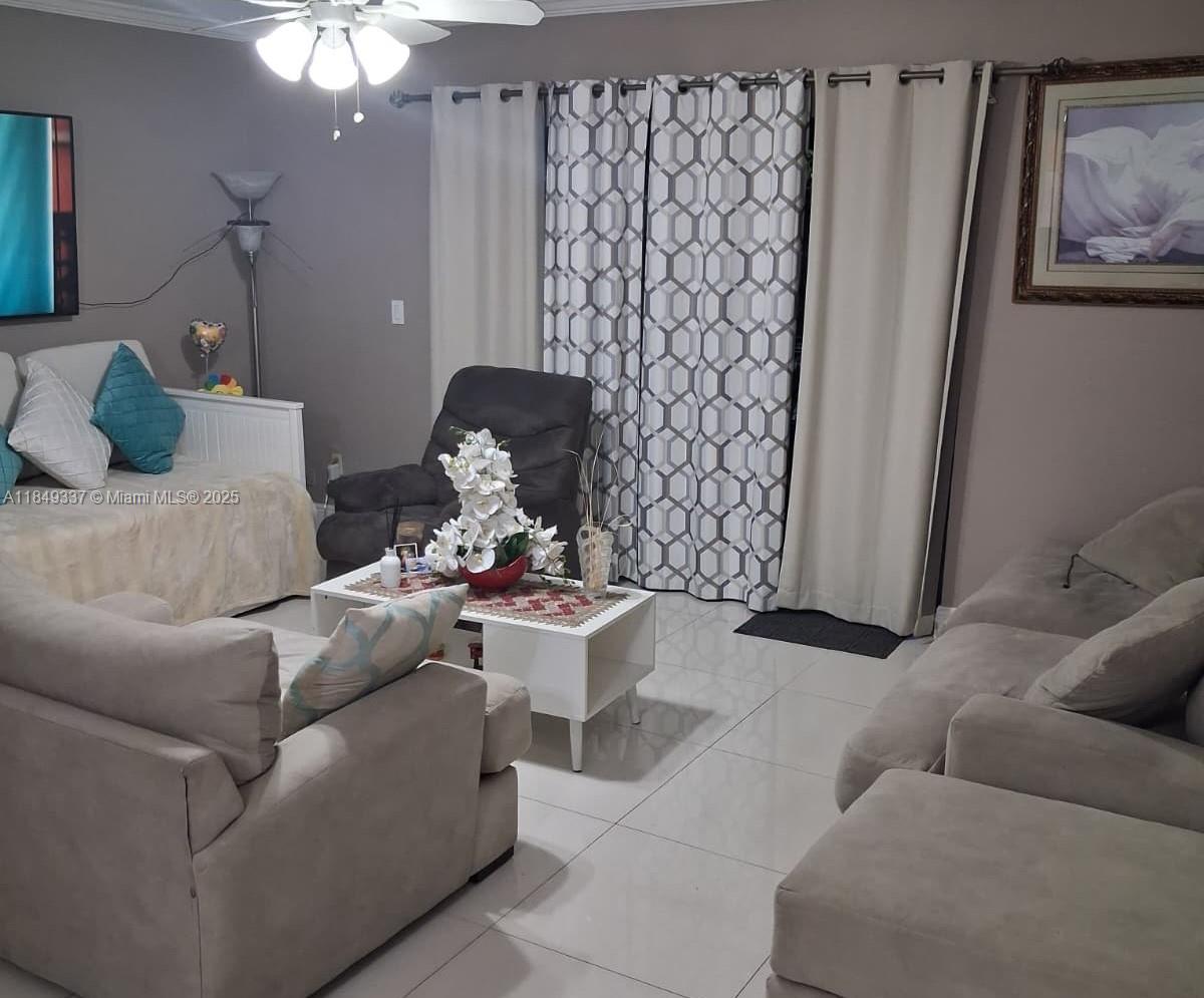 a living room with furniture and a large window