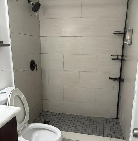 a bathroom with a toilet and a shower