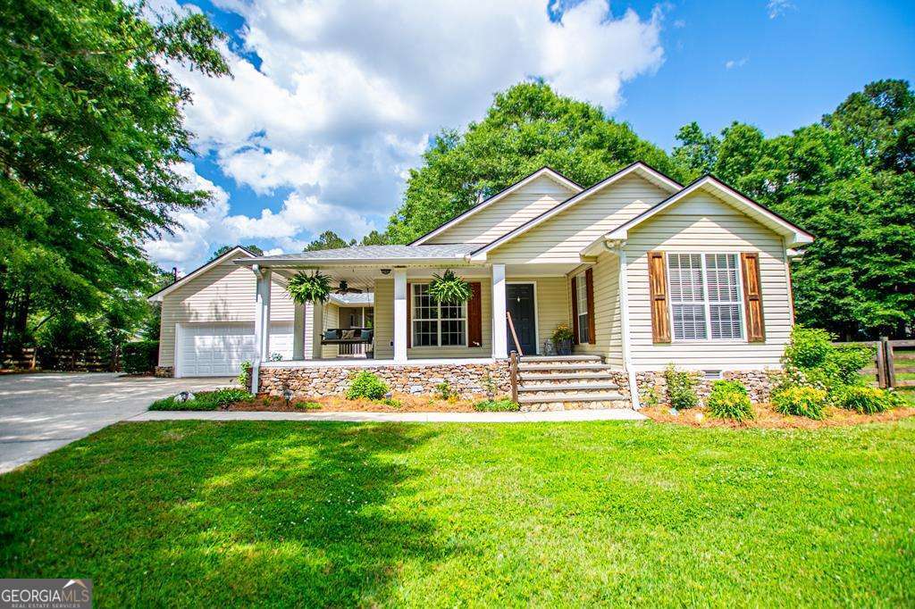 2 Pine Hill Drive Ranburne, AL 36273 - Photo 6 of 91 a front view of a house with a yard and porch