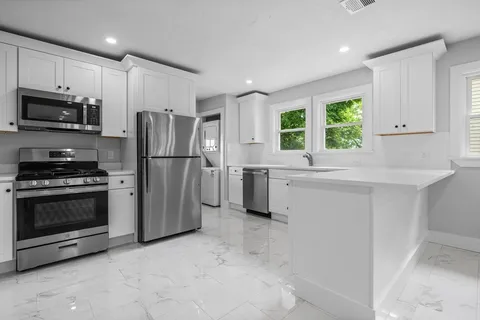 a kitchen with a refrigerator and a sink