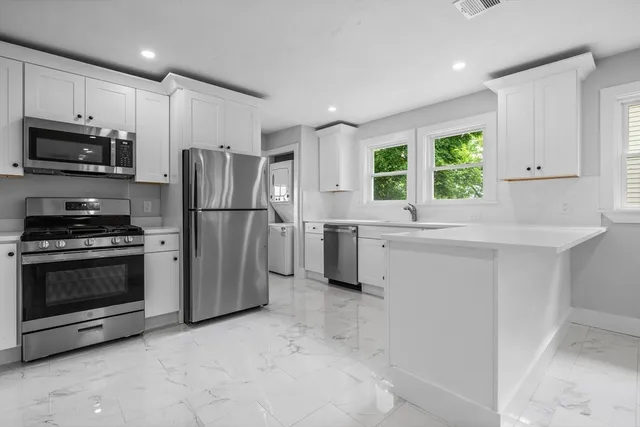 a kitchen with a refrigerator and a sink