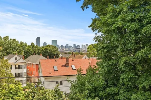 an aerial view of a house with outdoor space and garden