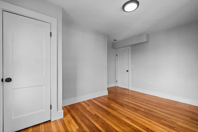 a view of a room with wooden floor and bathroom
