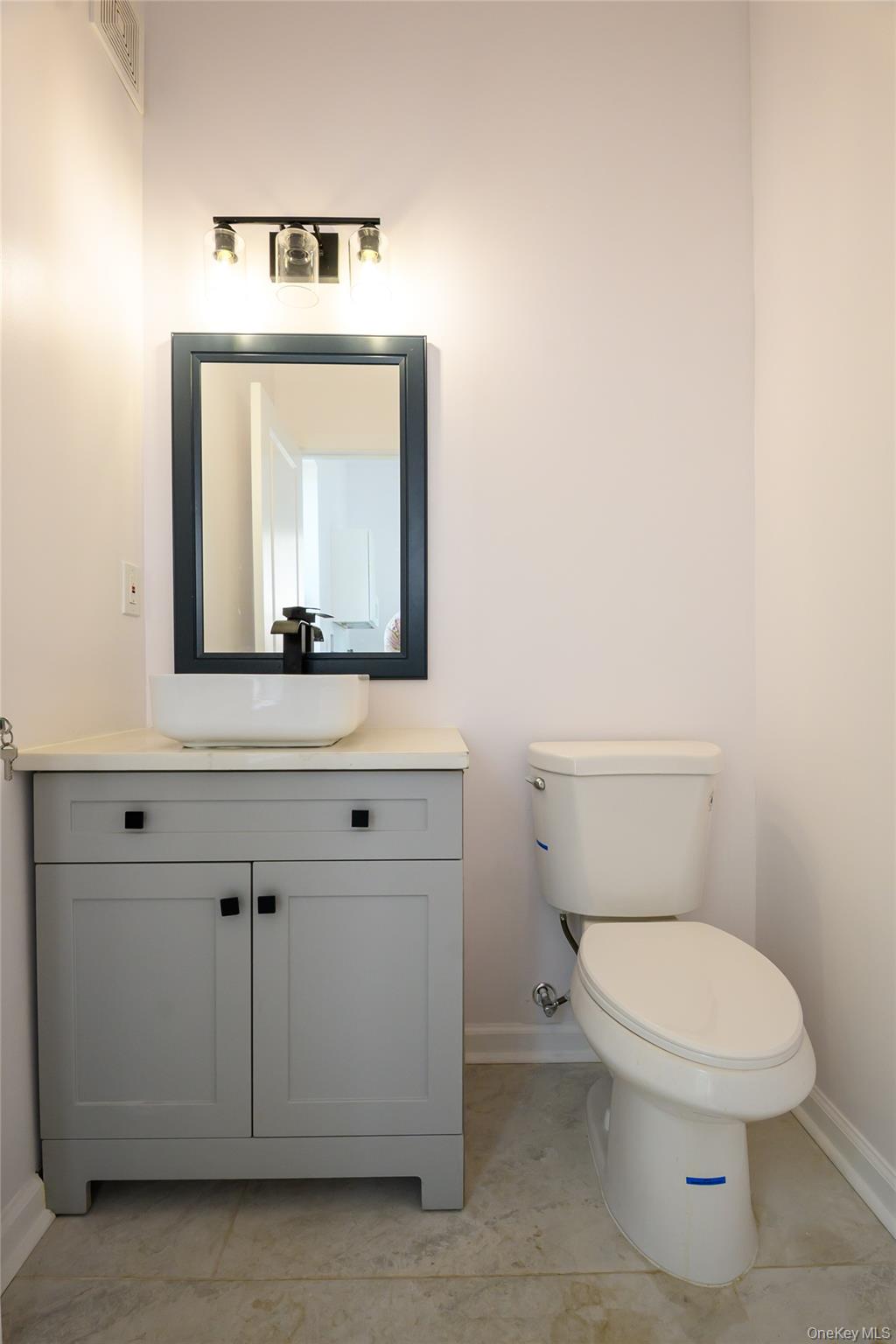 81 Silver Lake Sctn Road Middletown, NY 10940 - Photo 13 of 37 a bathroom with a toilet sink and mirror