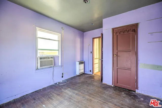 a view of a livingroom with an empty space and a window