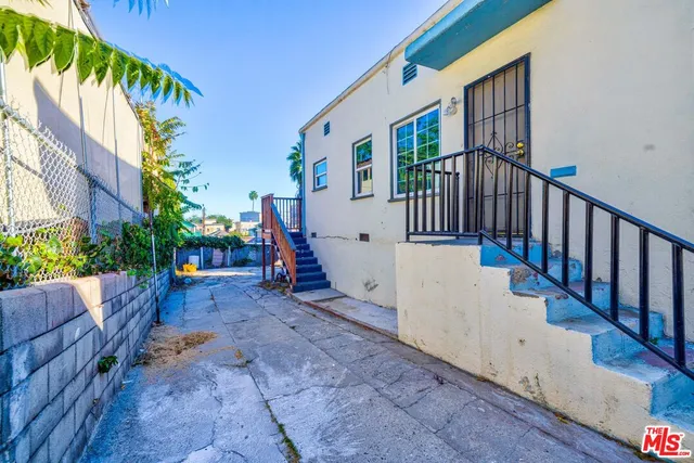 a view of a backyard with plants and a patio