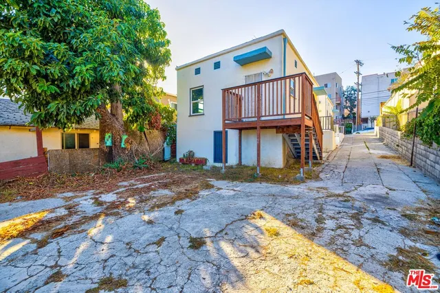 a view of a backyard with swimming pool