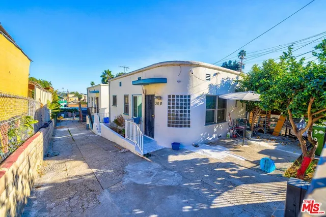 a view of a house with sitting area and garden