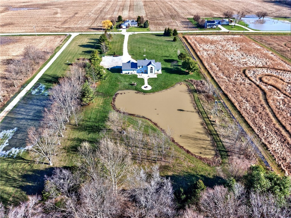6560 Snyder Road Fletcher, OH 45326 - Photo 63 of 71 This property features a charming home nestled among vast open fields with a private pond.