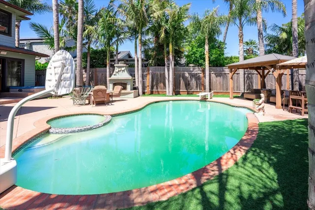 a view of a swimming pool with lounge chairs