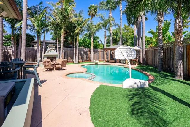 a view of a backyard with swimming pool