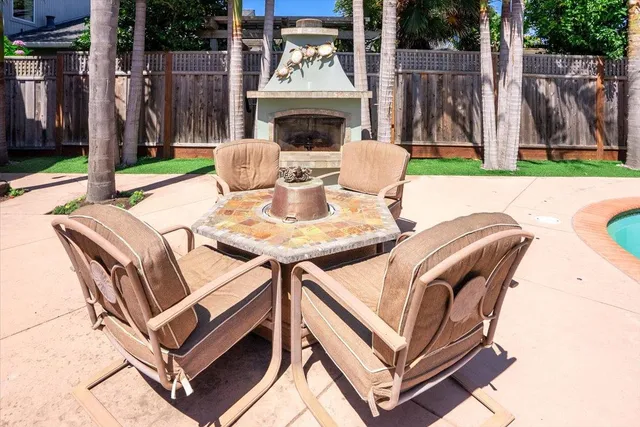 a view of a patio with a table and chairs