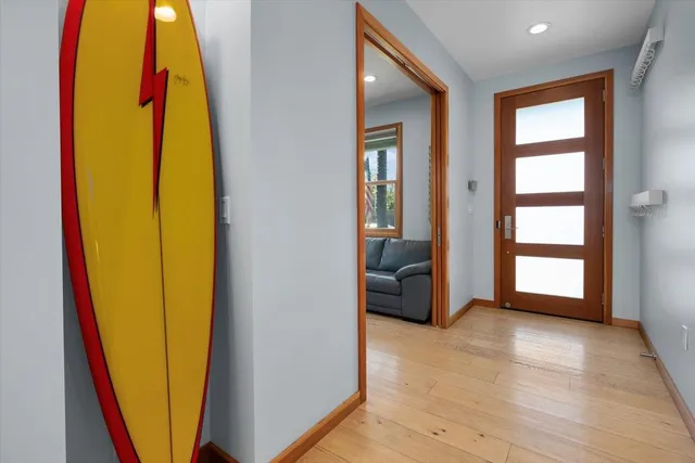 a view of a bedroom with a bed and wooden floor