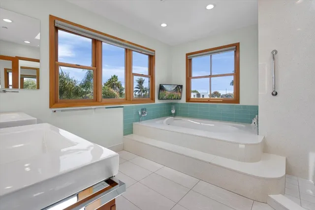 a bathroom with a bathtub and next to a window