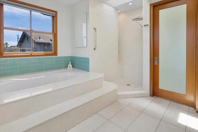 a spacious bathroom with a bathtub and a shower