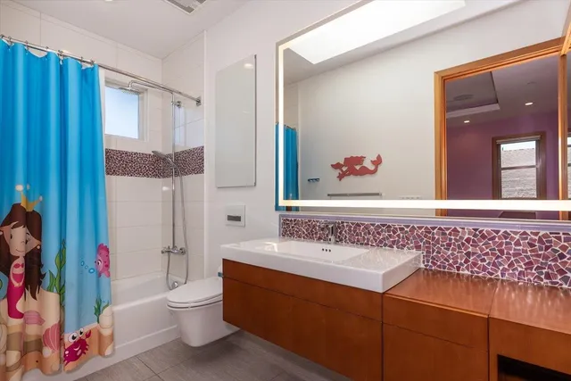 a bathroom with a sink mirror vanity and toilet