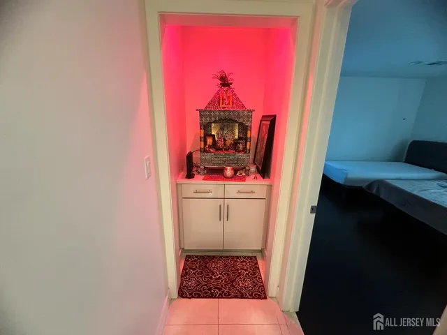 a bedroom with two beds and wooden floor