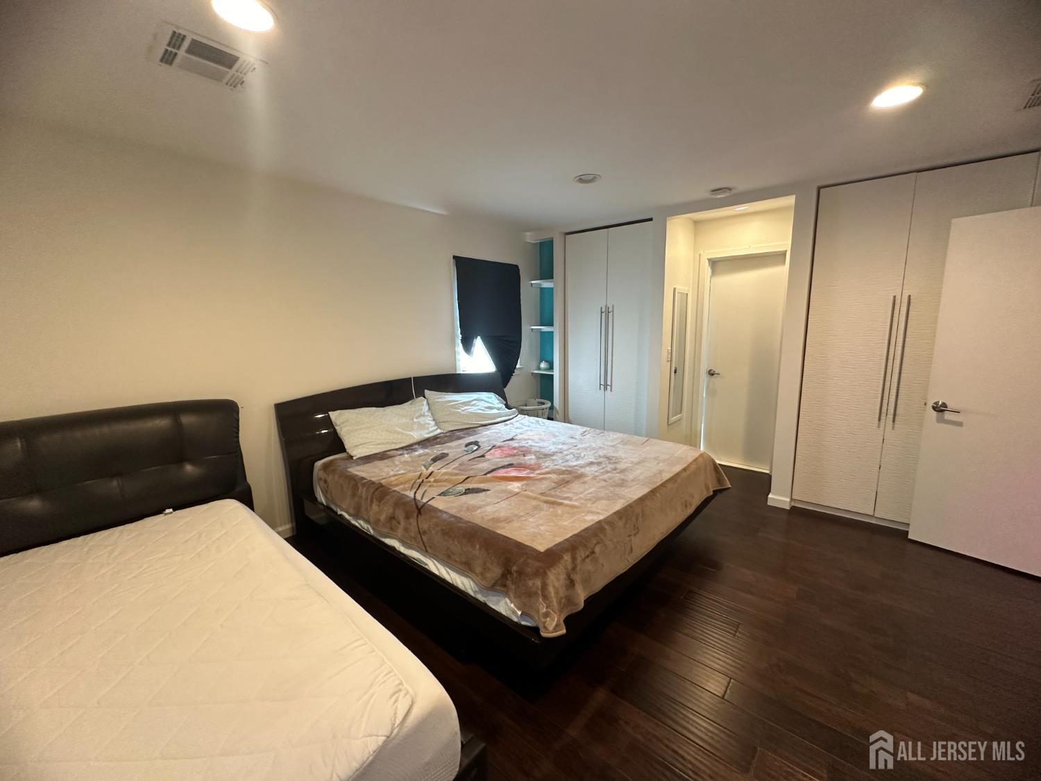 9 Holly Road Iselin, NJ 08830 - Photo 15 of 31 a bedroom with two beds and wooden floor