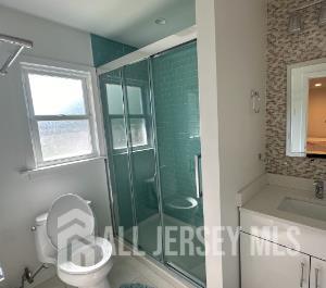 9 Holly Road Iselin, NJ 08830 - Photo 16 of 31 a bathroom with a sink toilet and shower