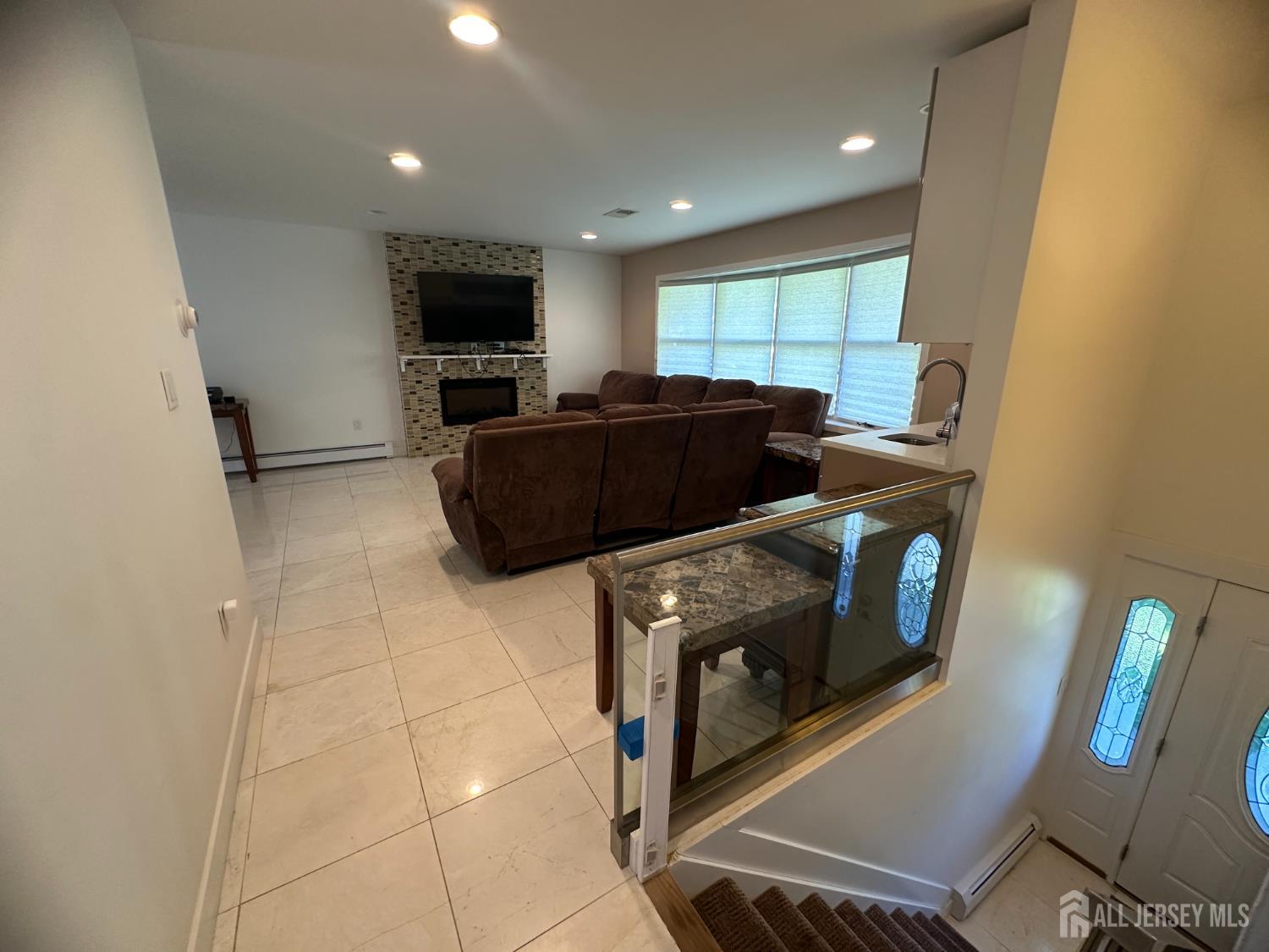 9 Holly Road Iselin, NJ 08830 - Photo 18 of 31 a living room with furniture and a flat screen tv