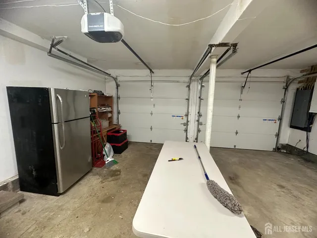 a large kitchen with a large counter top stainless steel appliances and cabinets