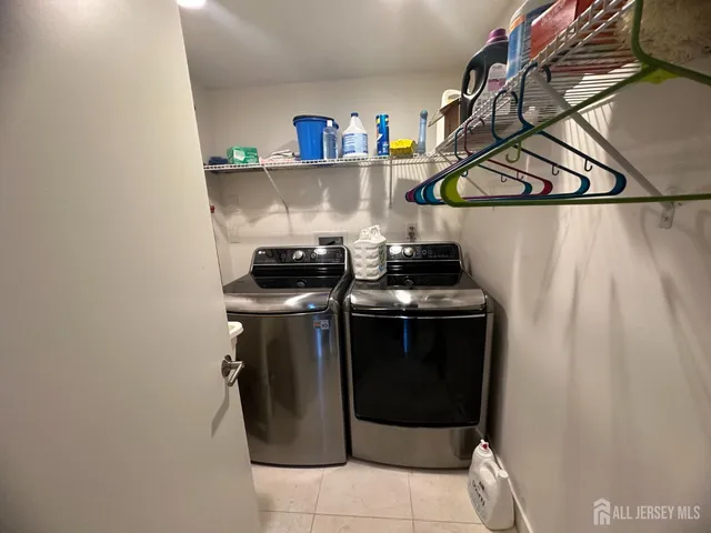 a kitchen with stainless steel appliances granite countertop a stove a refrigerator a oven a large island with a dining table and chairs