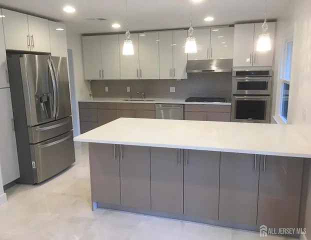 a open kitchen with a sink and a fireplace