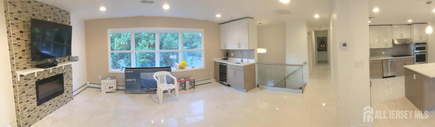 9 Holly Road Iselin, NJ 08830 - Photo 24 of 31 a open kitchen with a sink and a fireplace