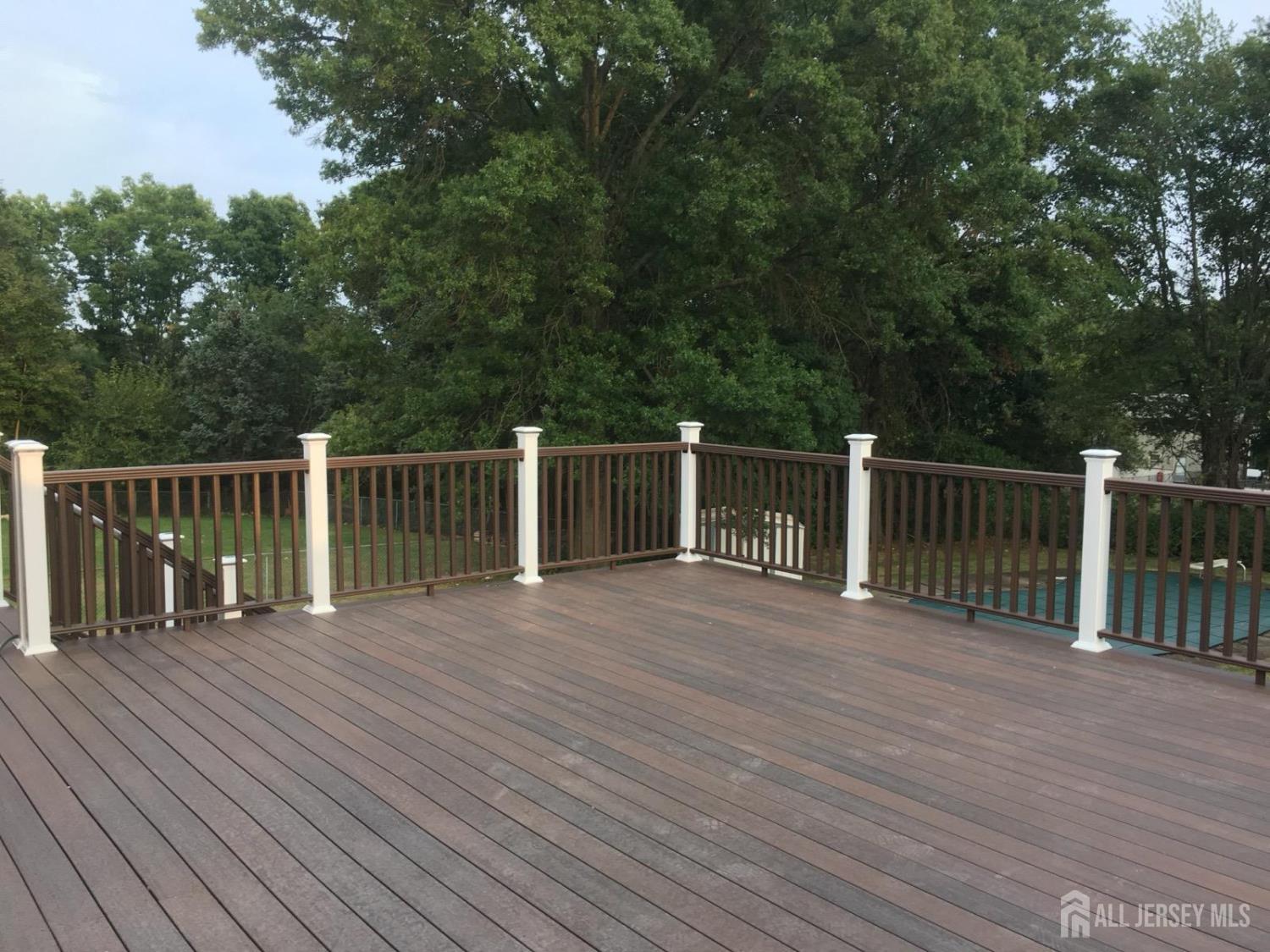 9 Holly Road Iselin, NJ 08830 - Photo 25 of 31 a view of a deck and a yard with wooden fence