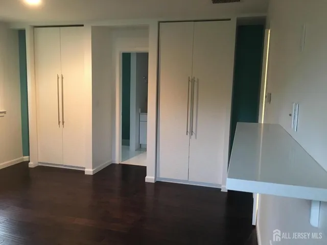 a view of a kitchen with a sink and a refrigerator
