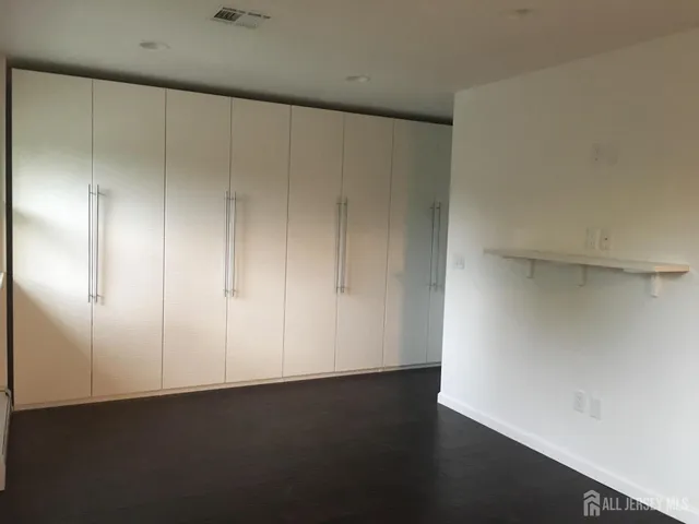 a view of a kitchen with a refrigerator and a sink