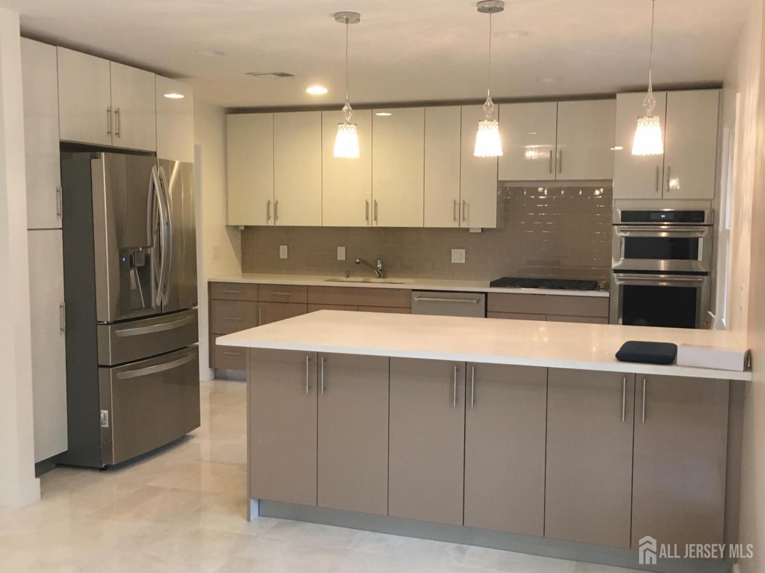 9 Holly Road Iselin, NJ 08830 - Photo 31 of 31 a view of a kitchen with a refrigerator and a sink