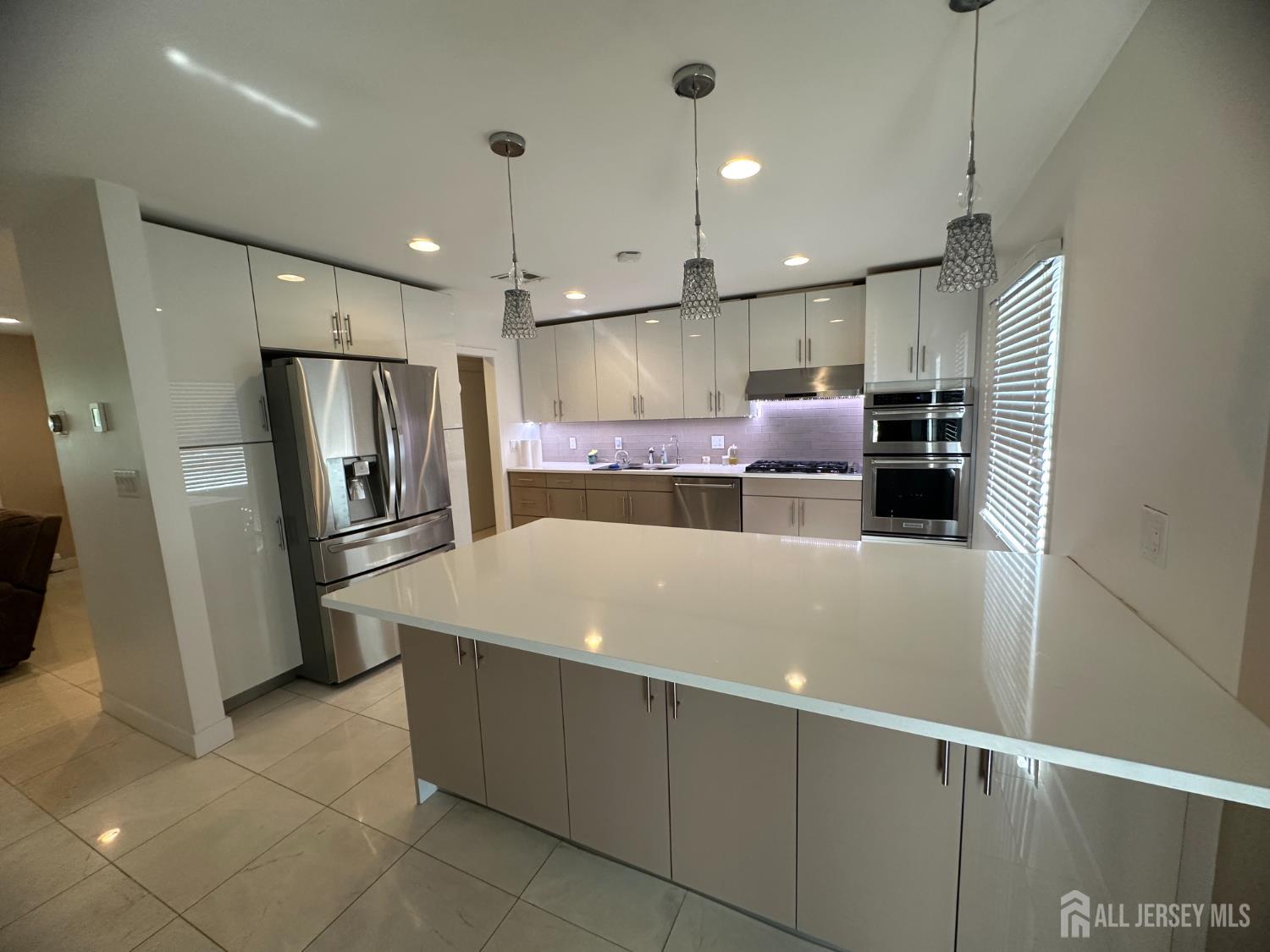 9 Holly Road Iselin, NJ 08830 - Photo 9 of 31 a large kitchen with stainless steel appliances kitchen island granite countertop a refrigerator a sink and a stove