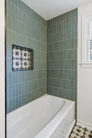 a bathroom with a bathtub and shower