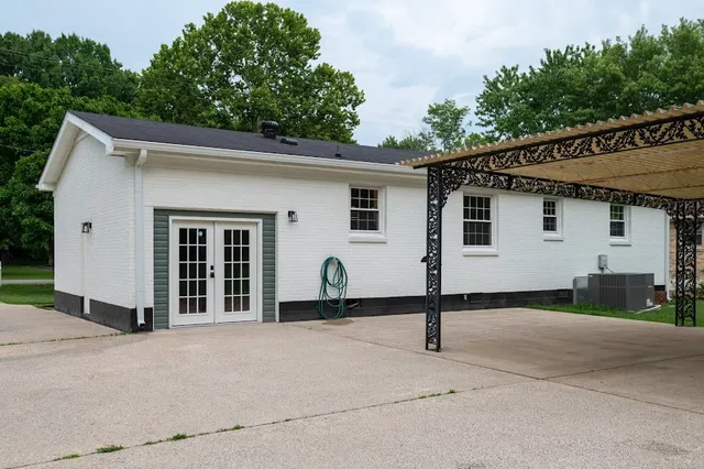 a view of a house with a backyard and a garage