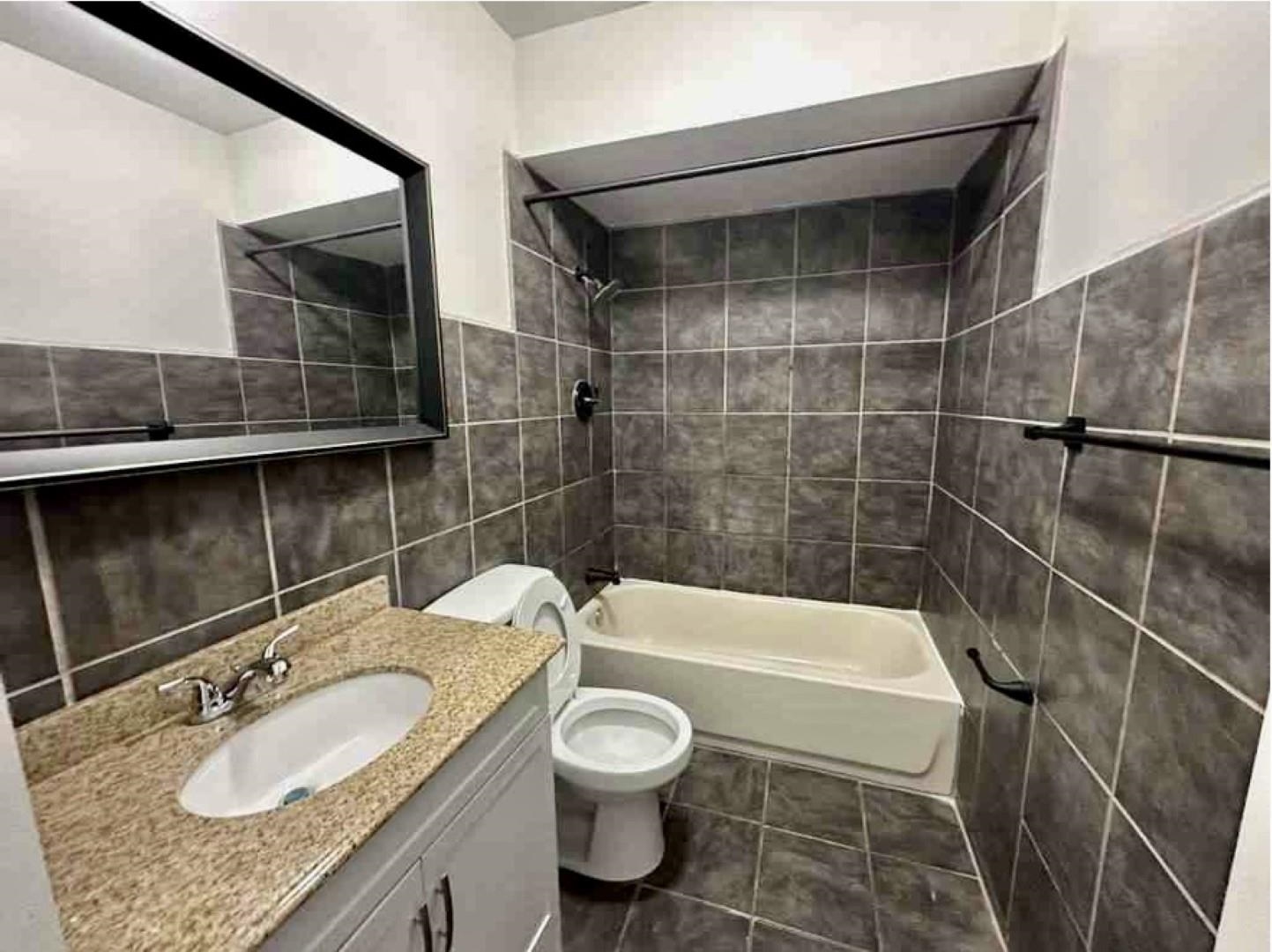 3442 Carrington Road Memphis, TN 38111 - Photo 12 of 25 Full bath with washtub / shower combination, toilet, tile walls, vanity, and tile patterned floors