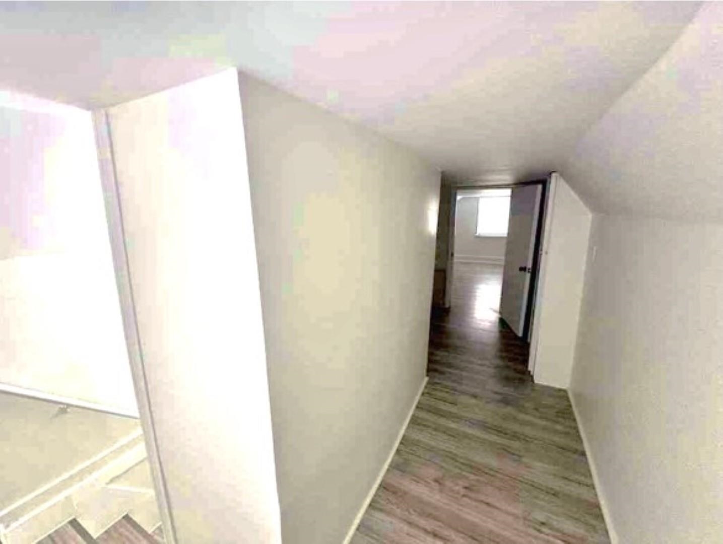 3442 Carrington Road Memphis, TN 38111 - Photo 22 of 25 Hall featuring lofted ceiling, baseboards, and wood finished floors