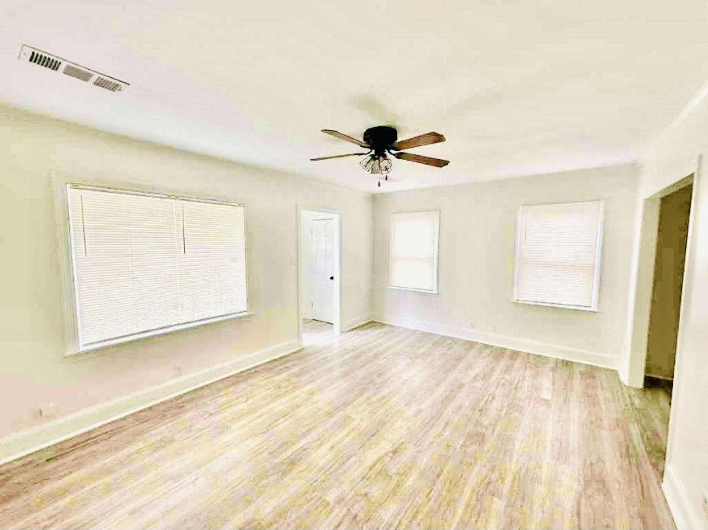 3442 Carrington Road Memphis, TN 38111 - Photo 6 of 25 Unfurnished room with light wood finished floors, baseboards, a ceiling fan, and visible vents