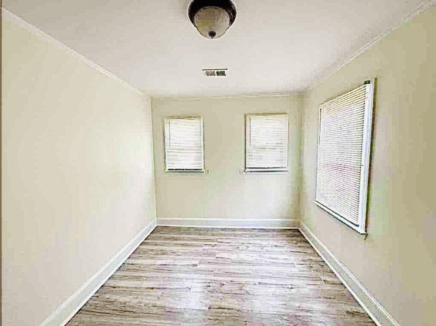 3442 Carrington Road Memphis, TN 38111 - Photo 9 of 25 Unfurnished room with visible vents, baseboards, and wood finished floors
