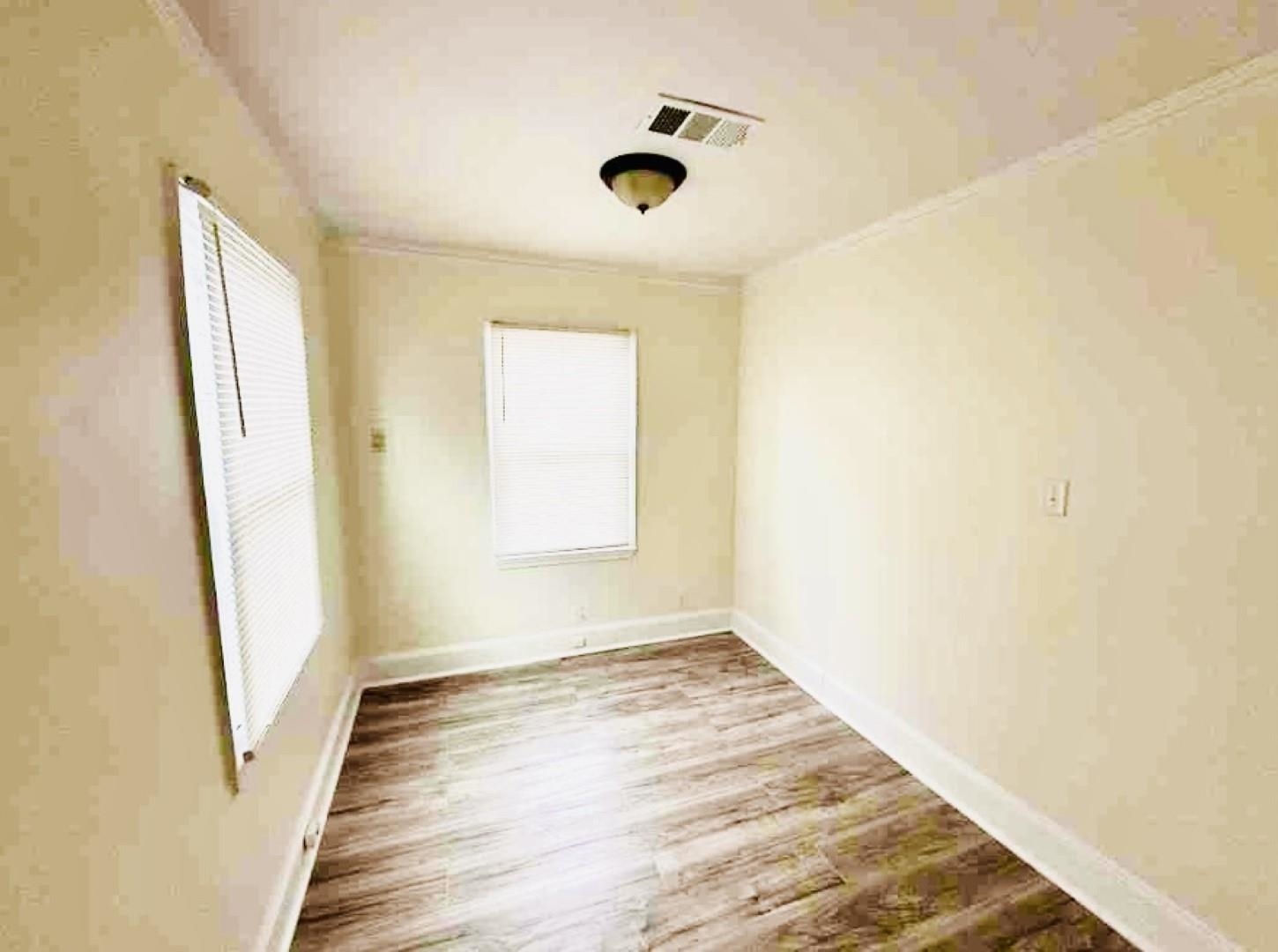 3442 Carrington Road Memphis, TN 38111 - Photo 10 of 25 Empty room featuring wood finished floors, baseboards, and visible vents