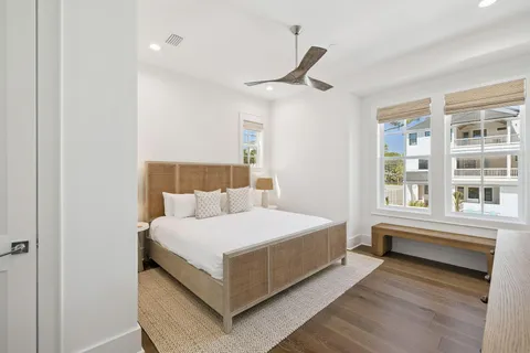 a spacious bedroom with a bed and a large window
